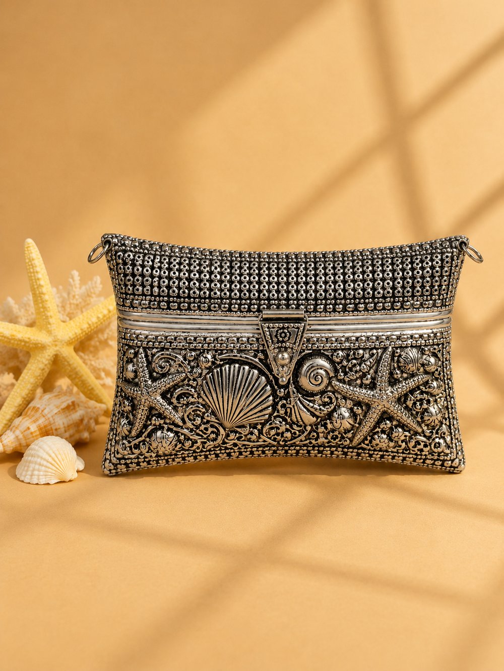 Close-up of Ocean Majesty's starfish and seashell engraving, styled with starfish and shells